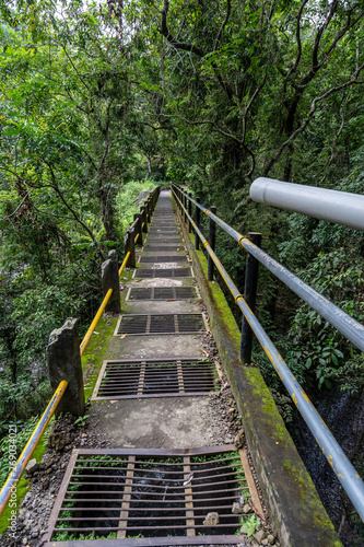 Fototapeta Naklejka Na Ścianę i Meble -  A broken bridge in the middel of the jungle on the way to the tiu kelep waterfall in Lombok, Indonesia