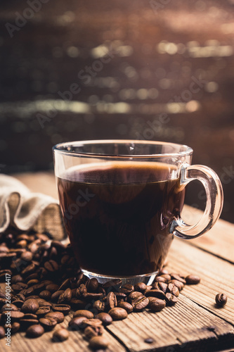 Cup of morning coffee on the rustic wooden background. Selective focus. Shallow depth of field.