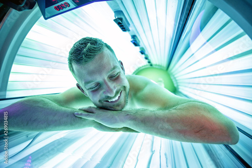 Man in sunbed relaxing and enjoying photo