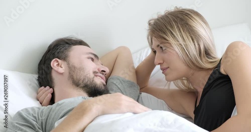 Woman talk to her man in bed. Caucasian man and woman. Beard, love and relationship concept.