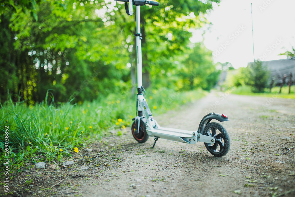 Ecological electric scooter wheel on a country road.