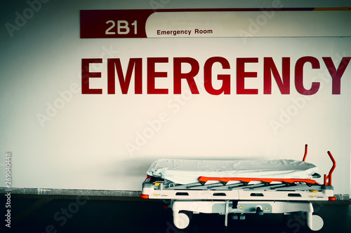 Fotografie Red emergency room sign and patient bed that looks scary