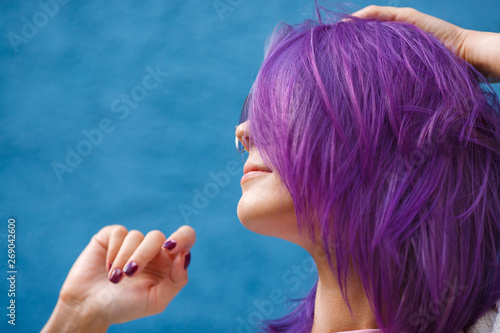 girl with purple hair on blue background