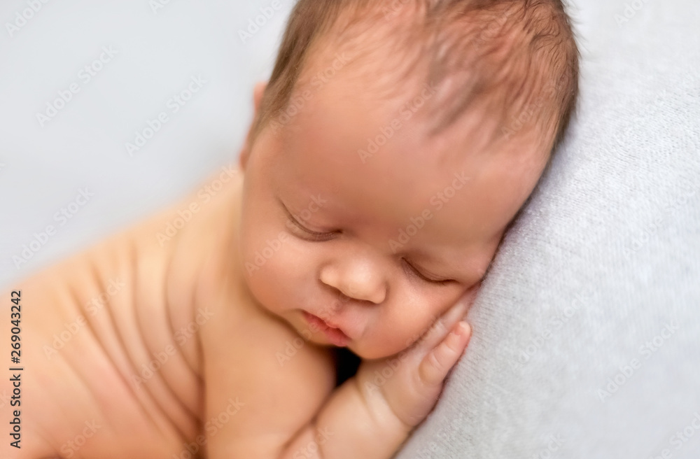 Sleeping newborn boy in the first days of life on white background Sleeping newborn boy in the first days of life on white background