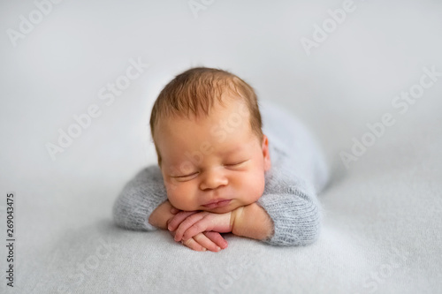 Sleeping newborn boy in the first days of life on white background