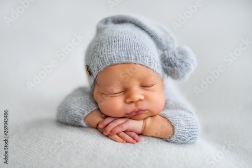 Sleeping newborn boy in the first days of life on white background photo