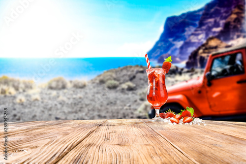 Desk of free space and summer car on beach 