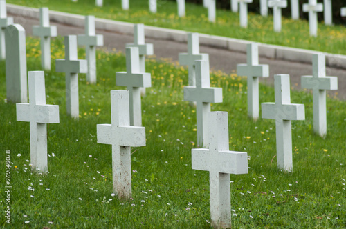 closeup of white cross alignment at military cemetery