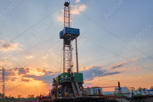 oil rig for drilling under oil and gas at sunset. Drilling oil and gas wells