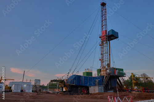 oil rig for drilling under oil and gas at sunset. Drilling oil and gas wells