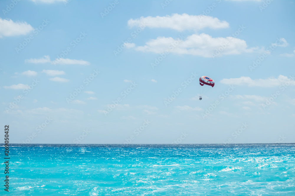 Parasail is flying over the Cancun caribbean sea