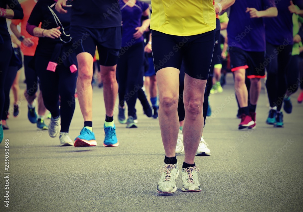 people with sport shoes during a race with old toned effect people with sport shoes during a race with old toned effect