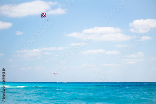 Parasail is flying over the Cancun caribbean sea