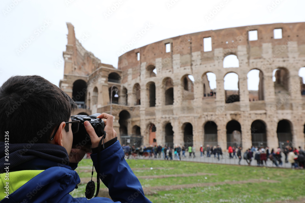 photographer taking a picture of the famous Roman Colosseum amph