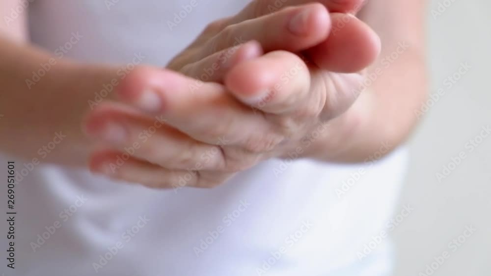 Hands of a young woman applying hand cream, hands massage Hands of a young woman applying hand cream, hands massage