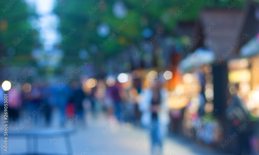 Defocused image of the street summer food festival in the evening