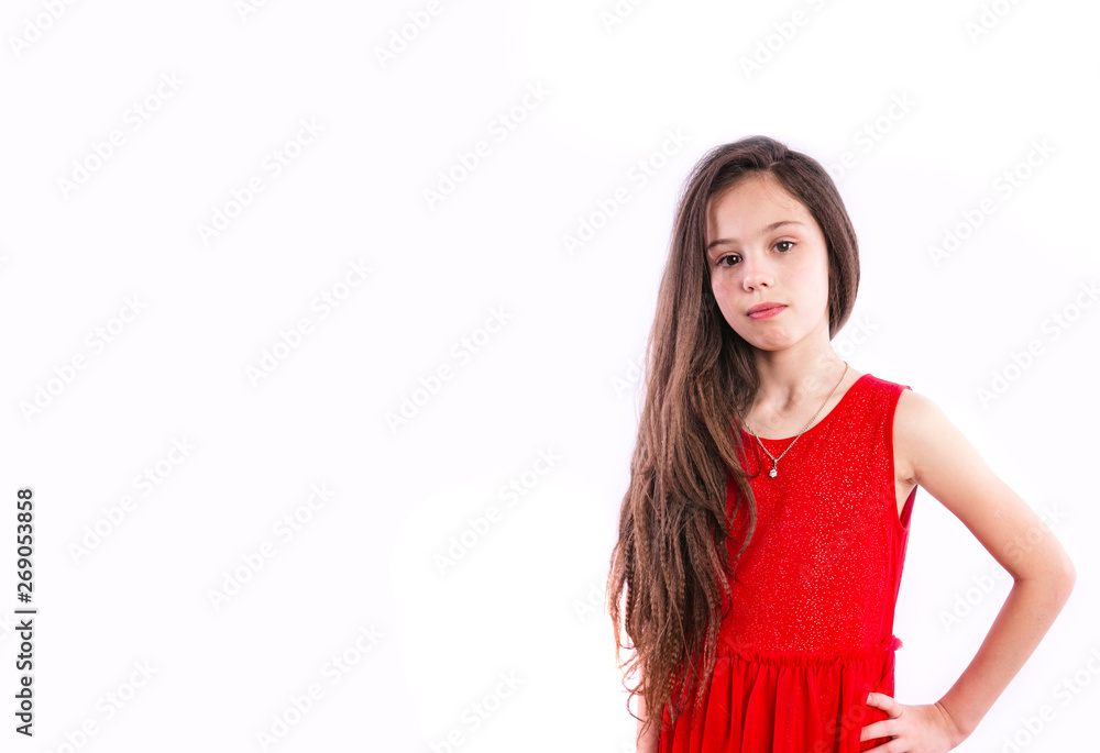 Child model on a white background. Little girl with long hair standing on white background Child model on a white background. Little girl with long hair standing on white background