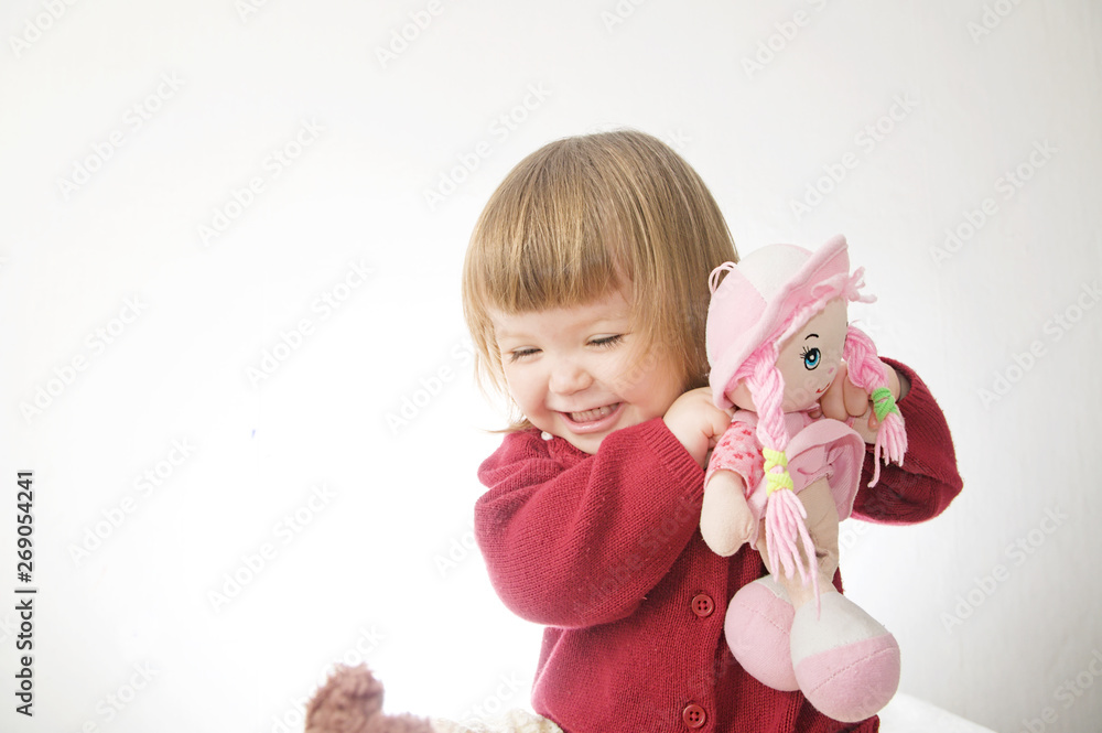 little girl smiling happy. cute caucasian baby with bear and doll isolated on white background little girl smiling happy. cute caucasian baby with bear and doll isolated on white background