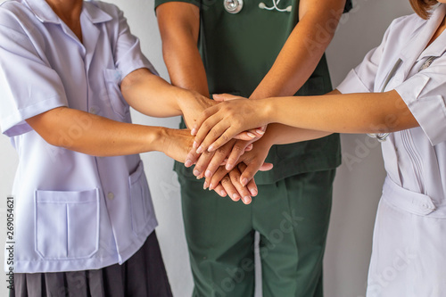 Doctors and nurses coordinate hands. Concept Teamwork in hospital for success work and trust in team © Kamonrat