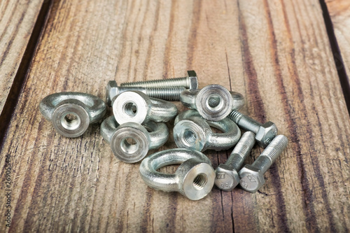 ring nuts with bolts, zinc plated on wooden background