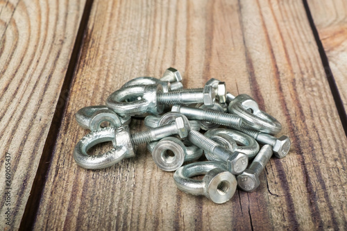 ring nuts with bolts, zinc plated on wooden background