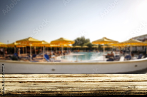 Desk of free space and swimming pool background 