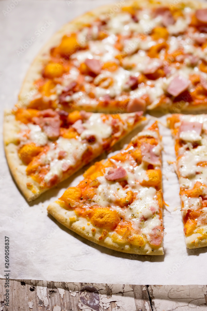 Pizza with cheese, ham and prosciutto