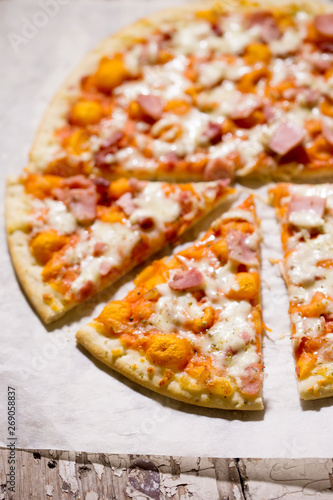 Pizza with cheese, ham and prosciutto