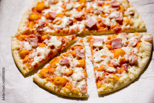 Pizza with cheese, ham and prosciutto