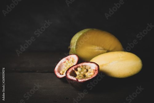 Mango and passion fruit on dark background