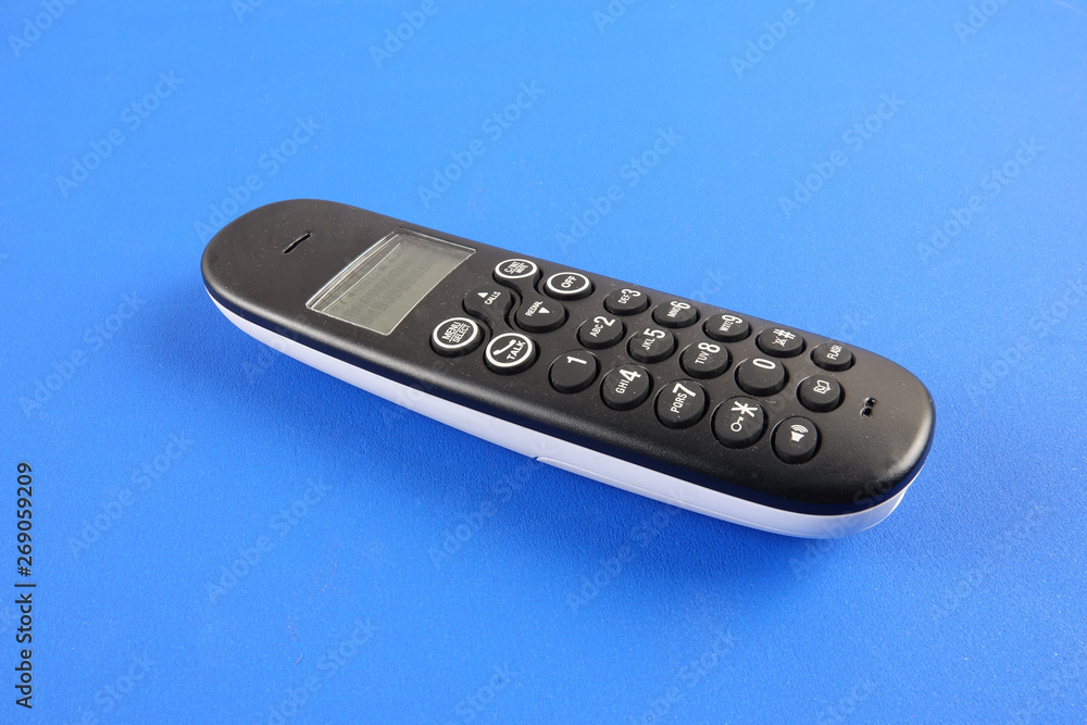 Top view of cordless phone over blue background. Top view of cordless phone over blue background.