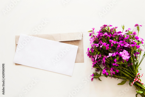 Purple flowers with paper on white background