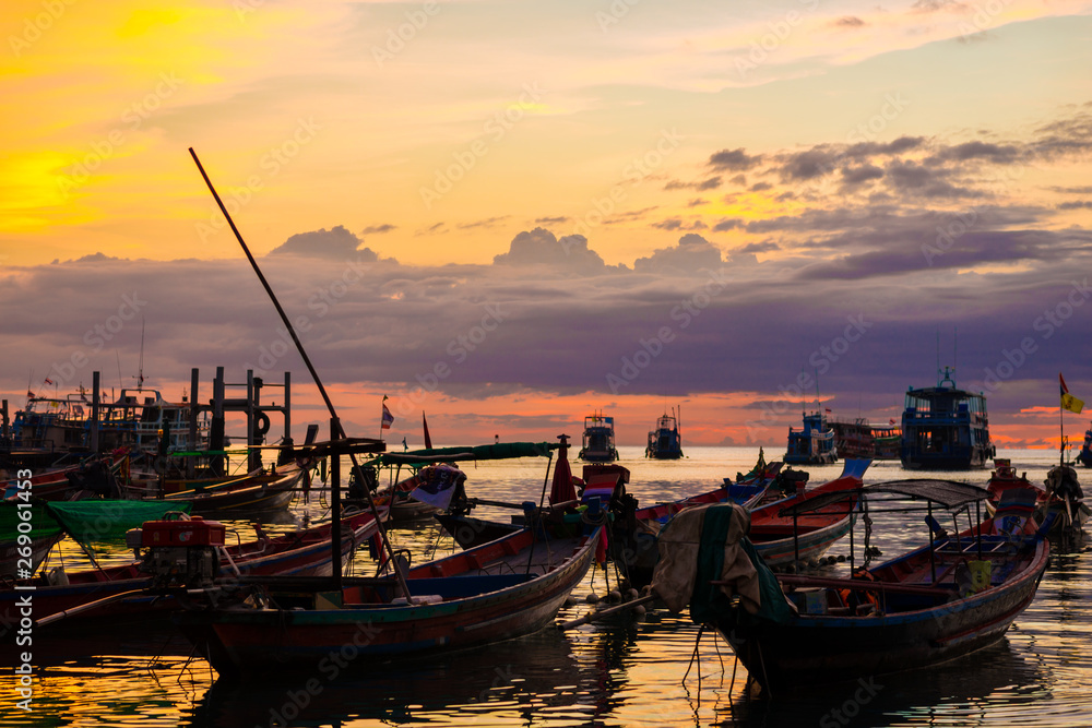 Silhouette seascape sunset wooden boat on sea shore