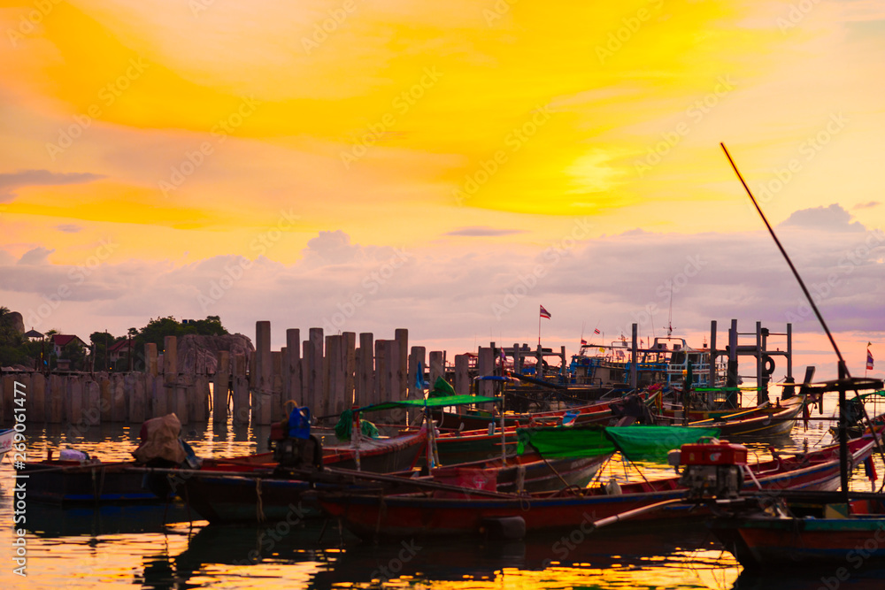 Fototapeta premium Silhouette seascape sunset wooden boat on sea shore