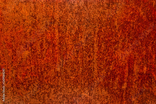 Worn iron sheet covered with red rust photo