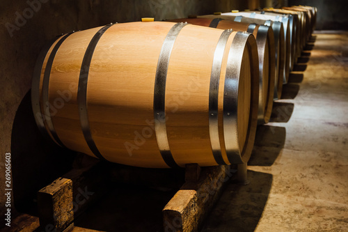 Wine maturing in oak barrels in a cellar.