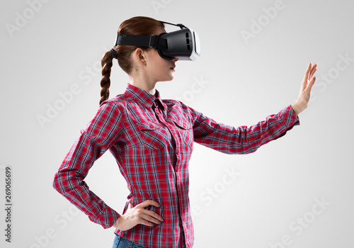 Girl in mask experiencing virtual reality as new entertainment device