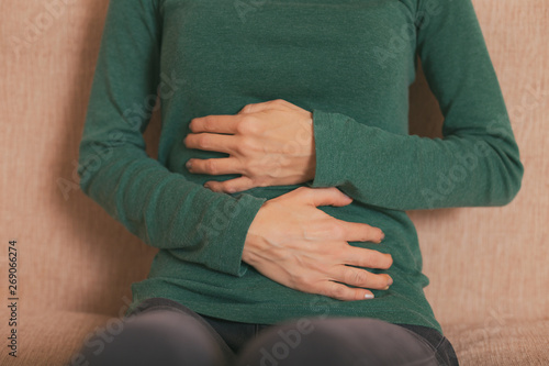 Woman having pain in her stomach.Toned photo.