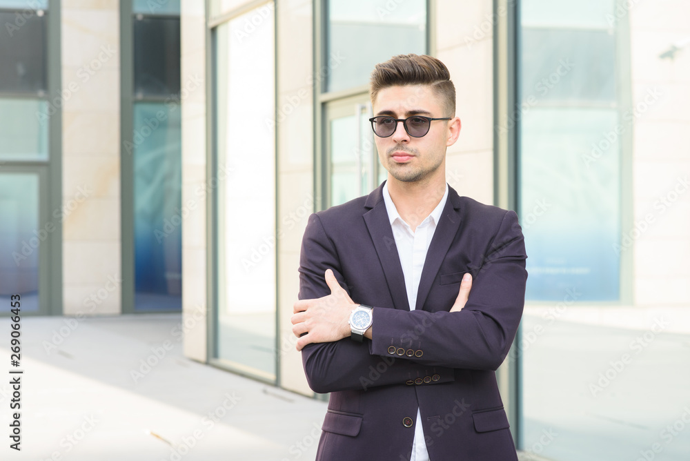 Portrait of successful businessman open in modern city near business center Portrait of successful businessman open in modern city near business center