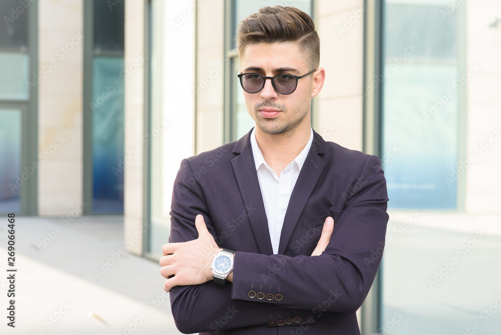 Portrait of successful businessman open in modern city near business center Portrait of successful businessman open in modern city near business center