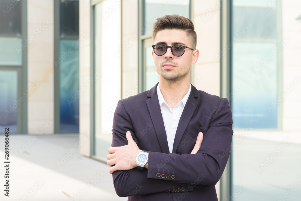 Portrait of successful businessman open in modern city near business center Portrait of successful businessman open in modern city near business center
