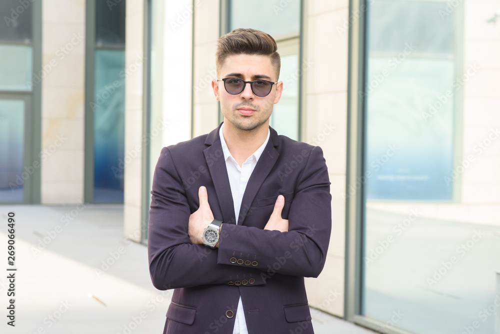 Portrait of successful businessman open in modern city near business center Portrait of successful businessman open in modern city near business center