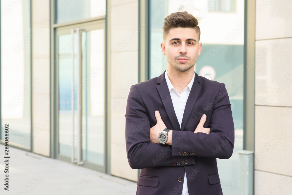 Portrait of successful businessman open in modern city near business center Portrait of successful businessman open in modern city near business center