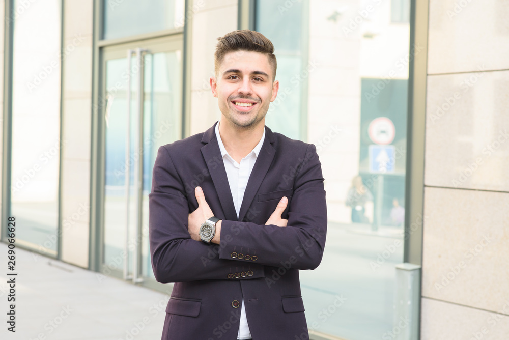 Portrait of successful businessman open in modern city near business center Portrait of successful businessman open in modern city near business center