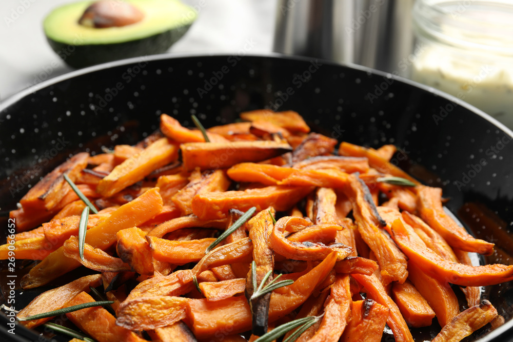 Dish with baked sweet potato slices, closeup Dish with baked sweet potato slices, closeup