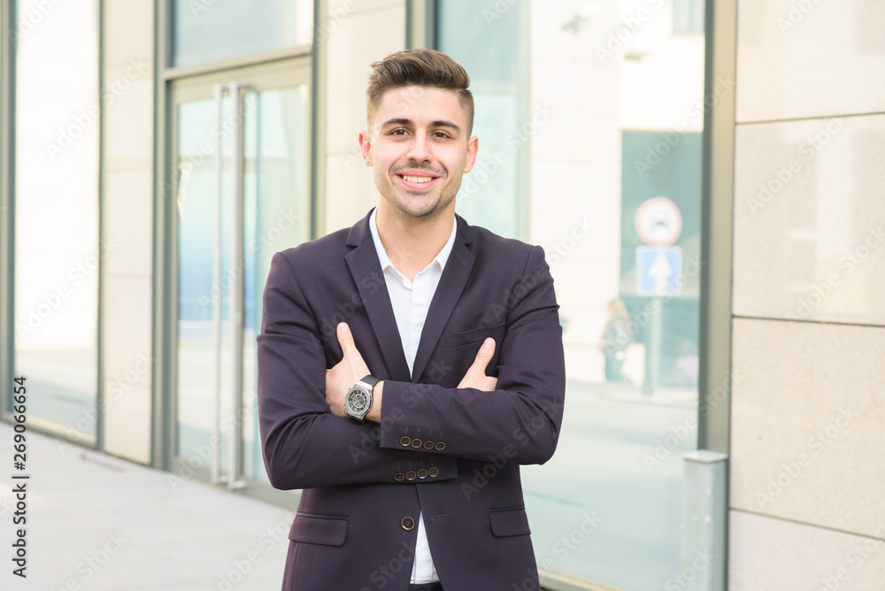 Portrait of successful businessman open in modern city near business center Portrait of successful businessman open in modern city near business center