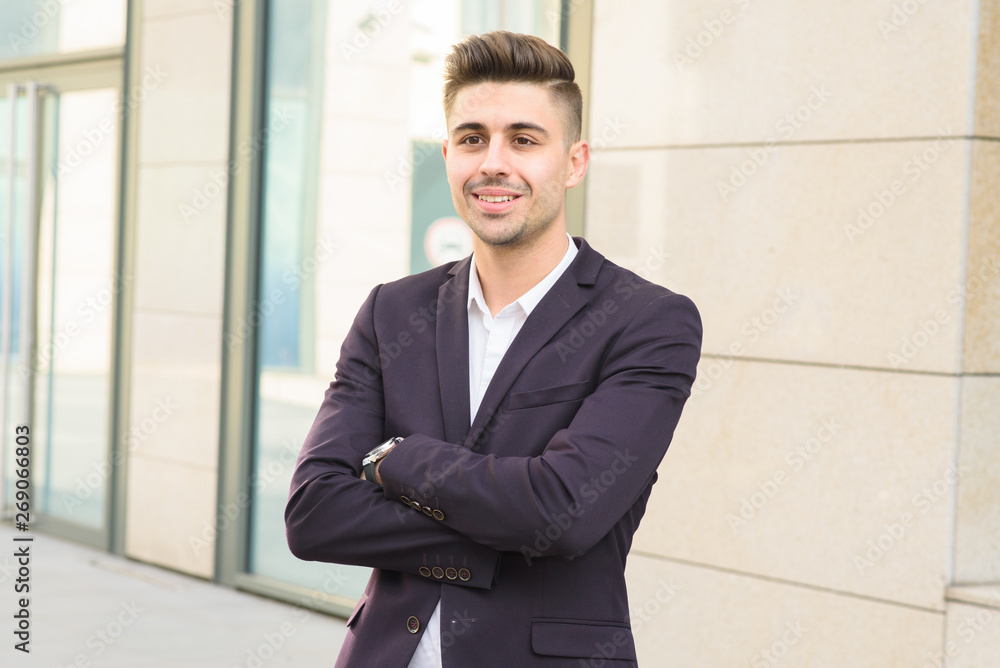 Portrait of successful businessman open in modern city near business center Portrait of successful businessman open in modern city near business center
