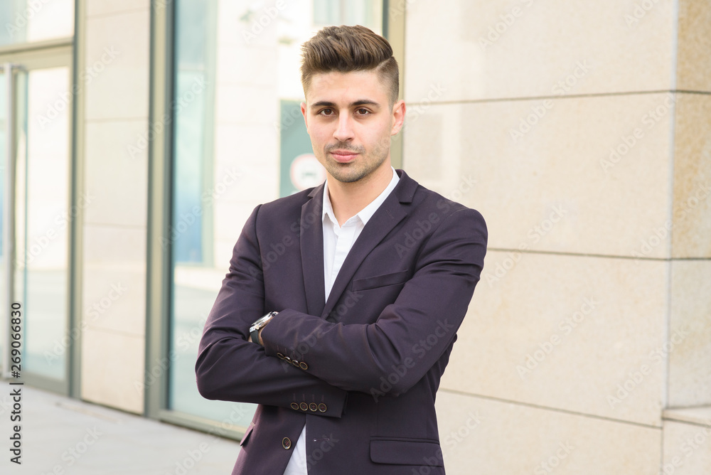Portrait of successful businessman open in modern city near business center Portrait of successful businessman open in modern city near business center