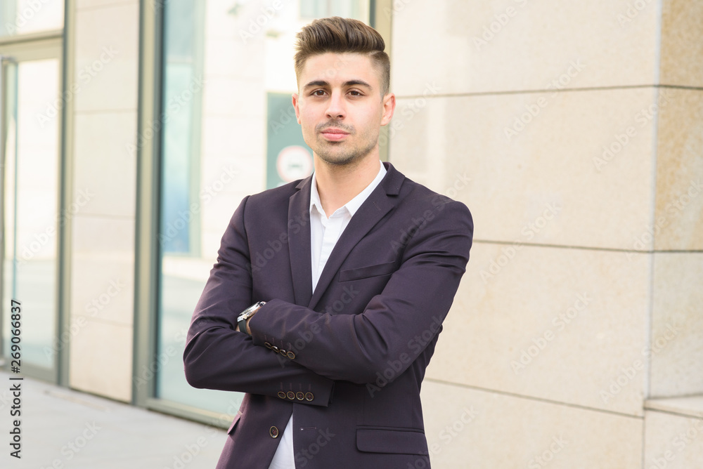 Portrait of successful businessman open in modern city near business center Portrait of successful businessman open in modern city near business center