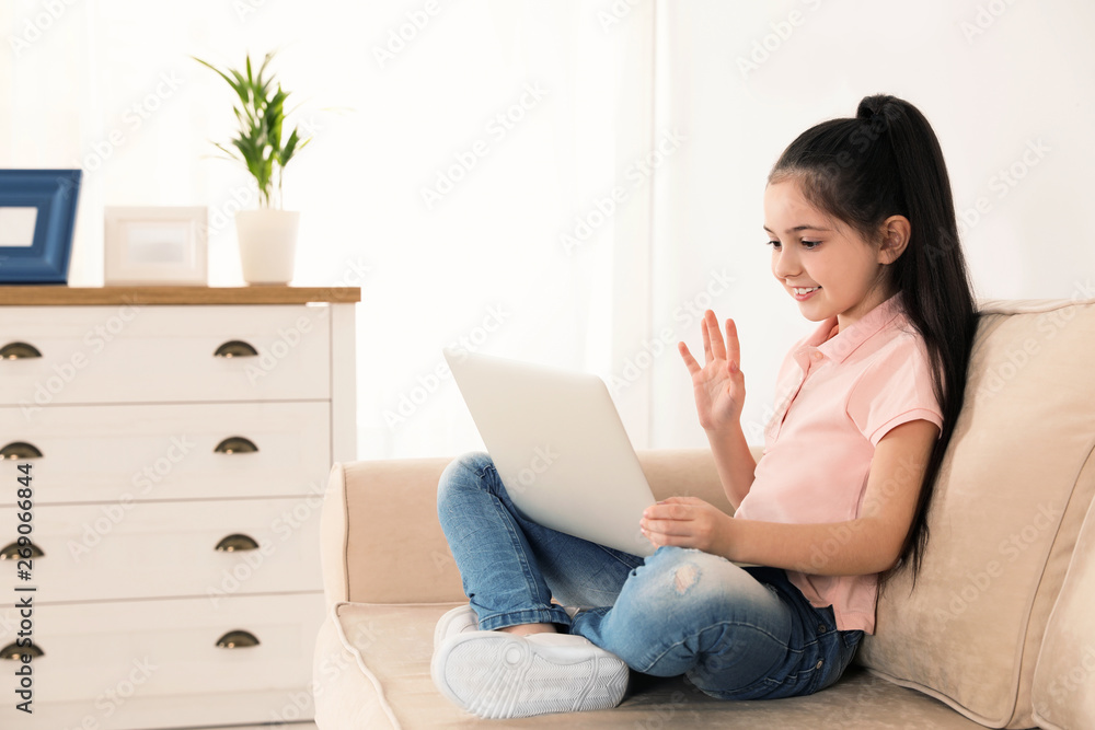 Little girl using video chat on laptop at home Little girl using video chat on laptop at home